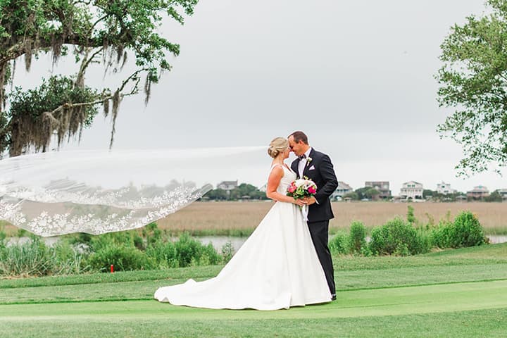Bride and groom ceremony at Pawleys Plantation saltwater marsh backdrop SC