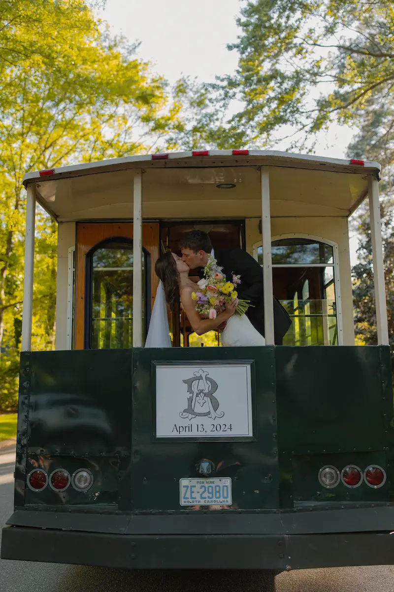 Poppies and Peonies - bridge and groom kiss in trolley