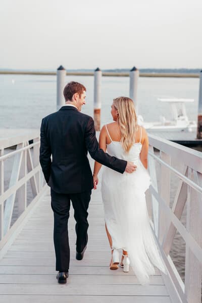 Bride and groom walking on dock at the Beaufort Inn