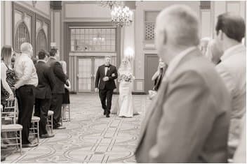 Bride walking down the aisle at The Westin Poinsett ballroom