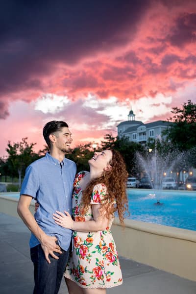 Couple laughing together in front of a brilliant Grand Strand sunset